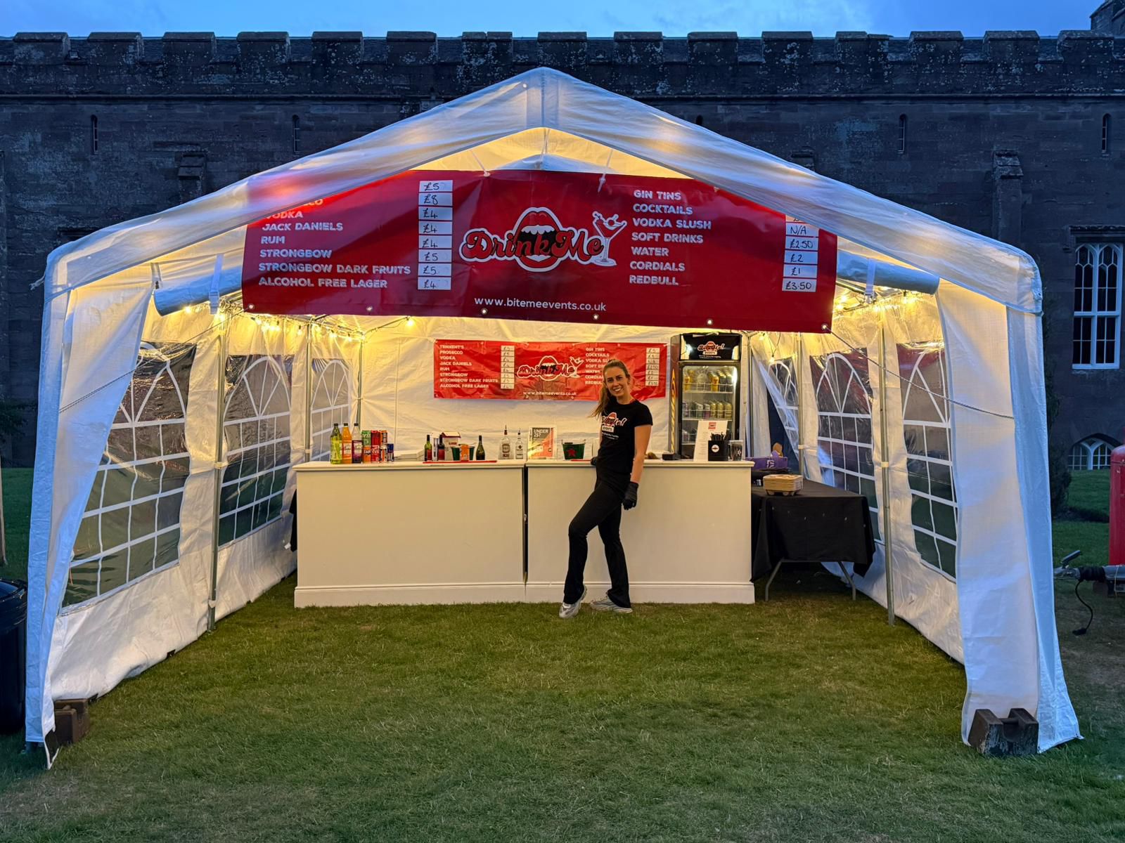 Drink Me pop-up bar at a castle event with fairy lights