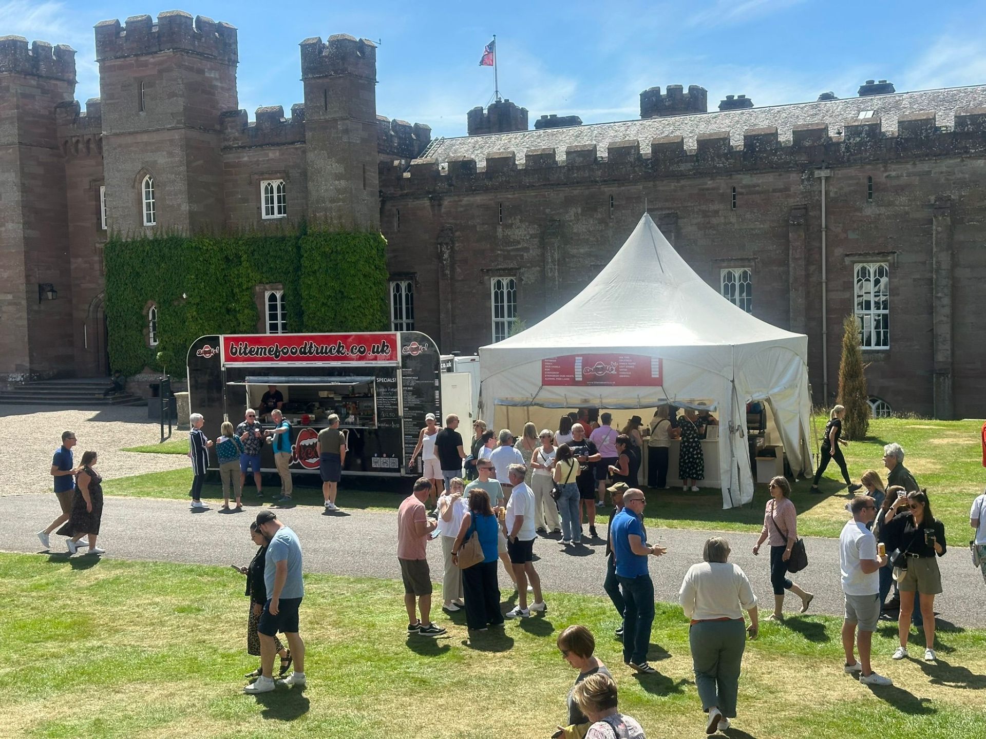 Bite Me food truck and bar serving crowds at Scone Palace on a sunny day